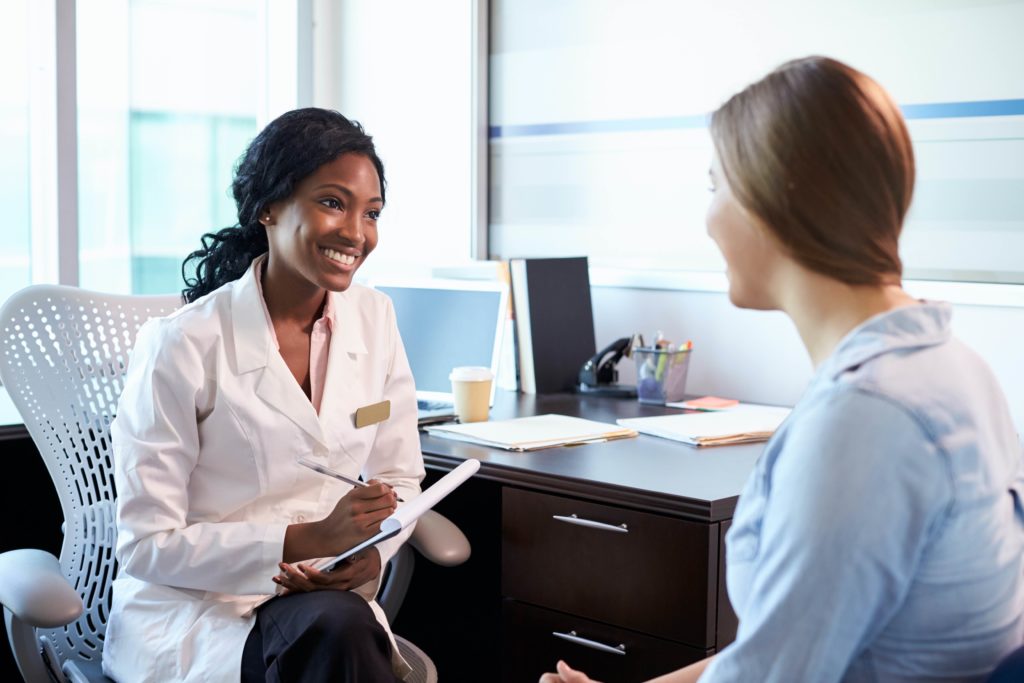 Female doctor consulting female patient.