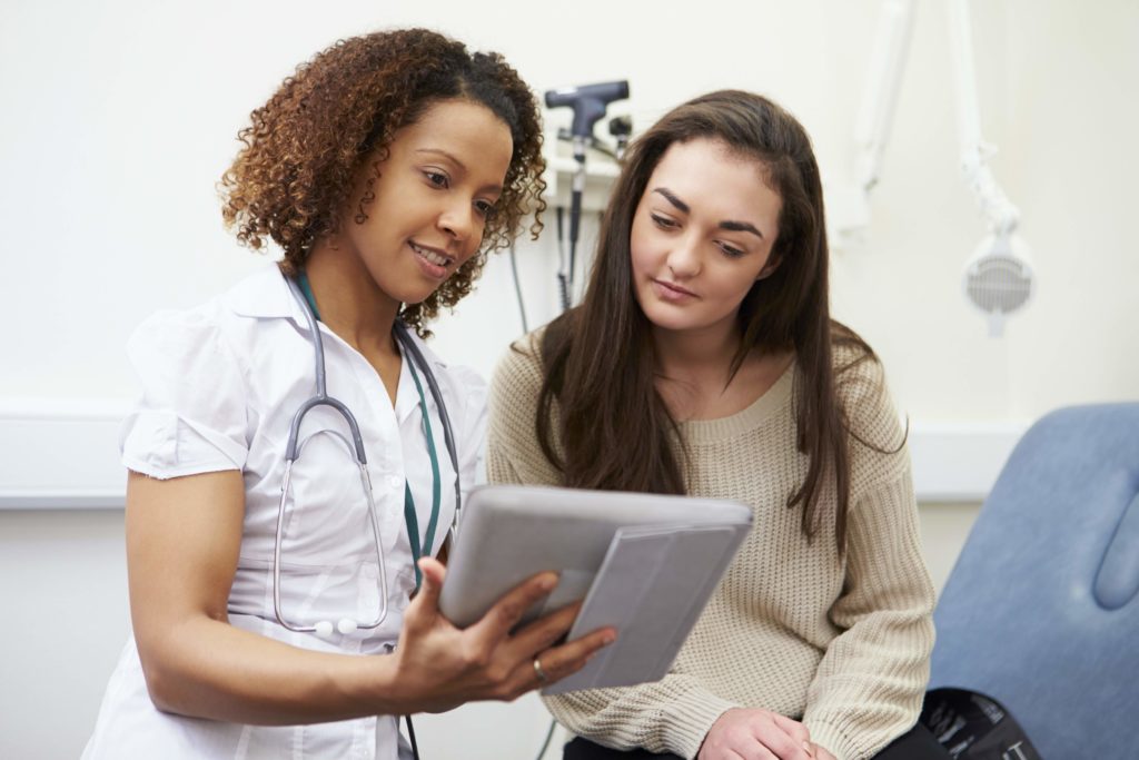 Gen Z patient talking with doctor.