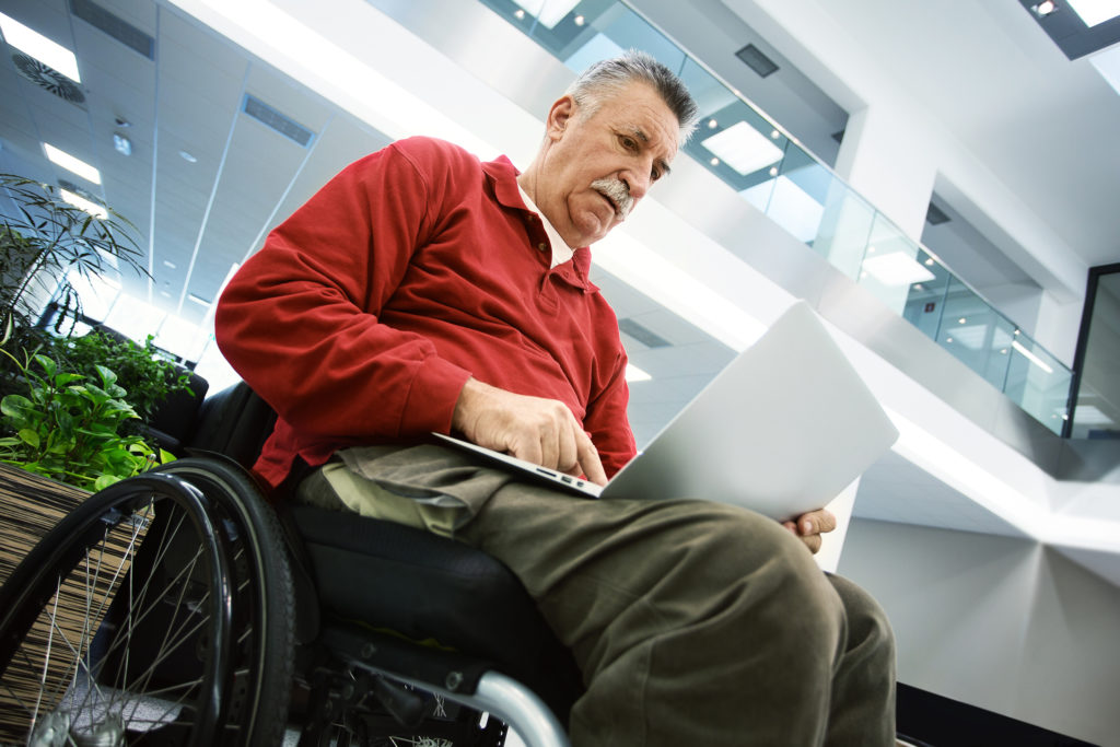 Elderly patient using laptop