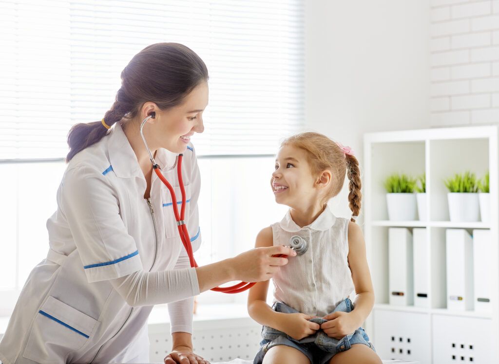 Pediatrician listening to child's heartbeat.