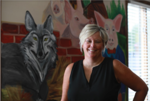 Elizabeth Flynn, MD, smiling at her practice, Manassas Pediatrics, in Northern Virginia.