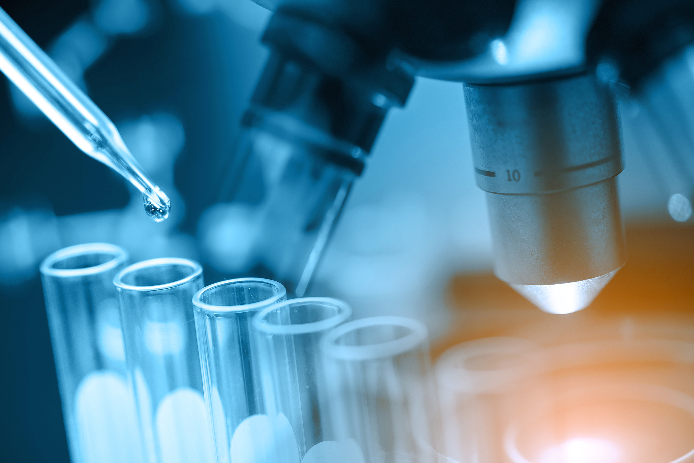 Image showing clinical research setting with microscope and lab glassware in science laboratory