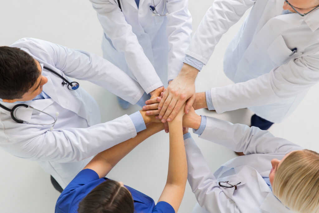 Doctors celebrating wins in value-based care.
