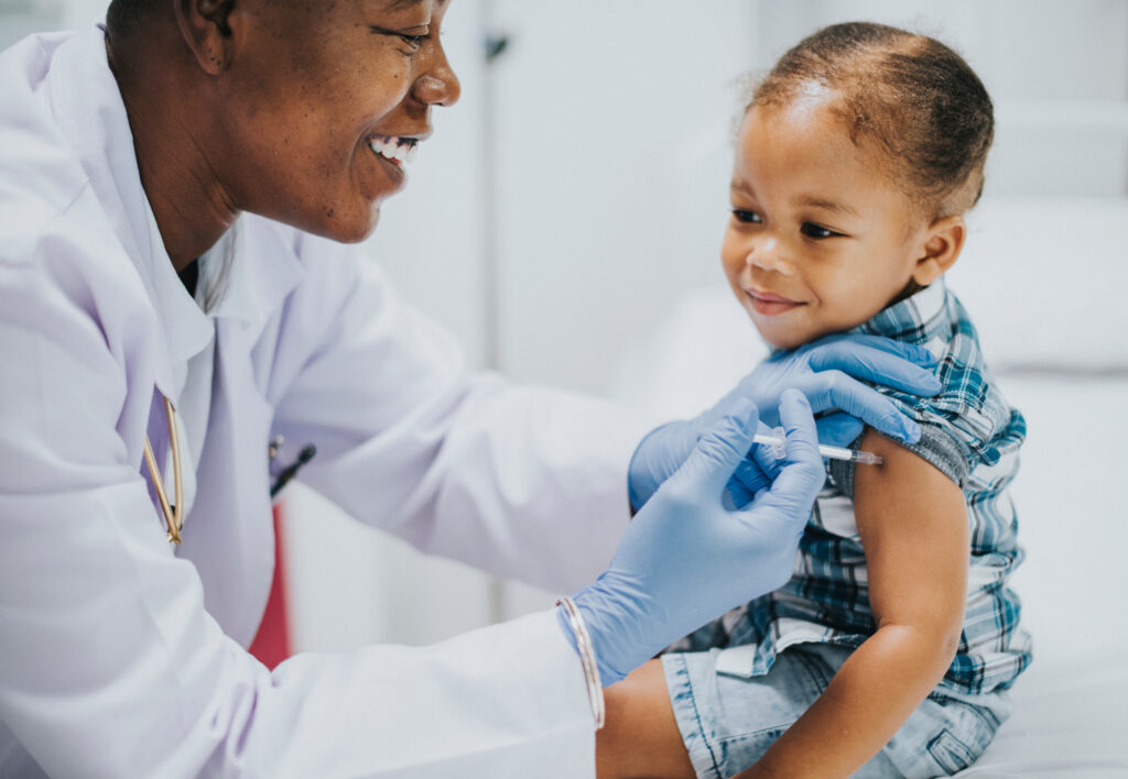 Allergy and immunology doctor giving child a shot.